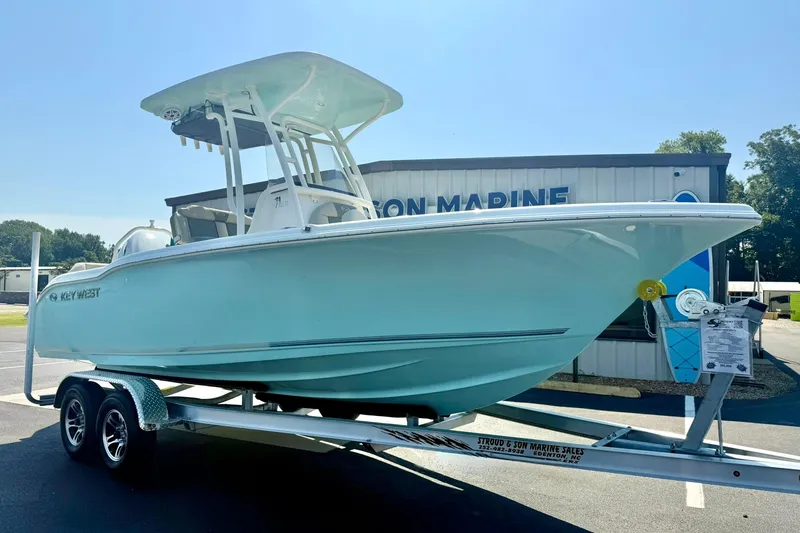The Image of 2026 Key West 219 FS boat on trailer outside marine dealership. - 1
