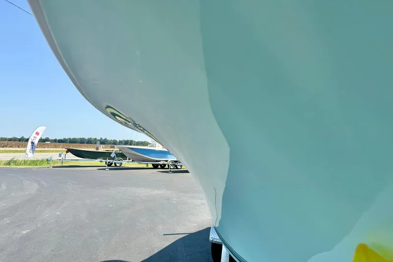 Slide: The Image of 2026 Key West 219 FS boat hull close-up, parked on asphalt with clear sky. - 10