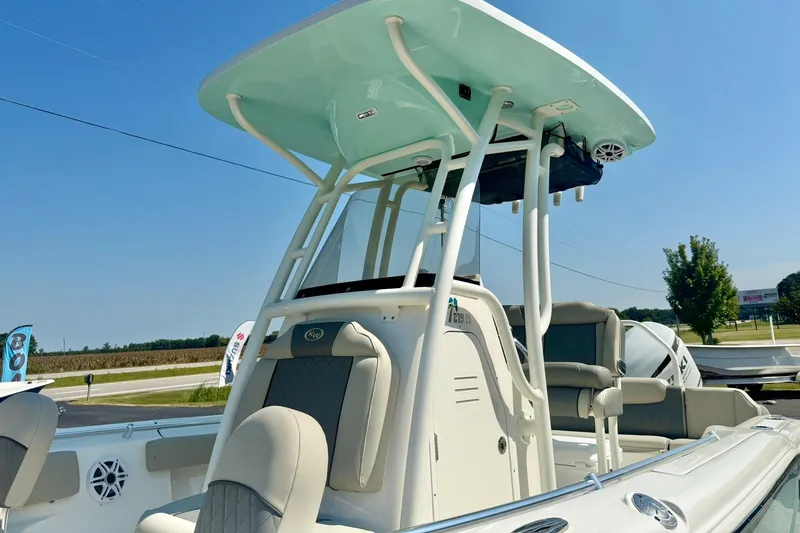 Slide: The Image of 2026 Key West 219 FS boat with T-top and seating, displayed outdoors. - 11