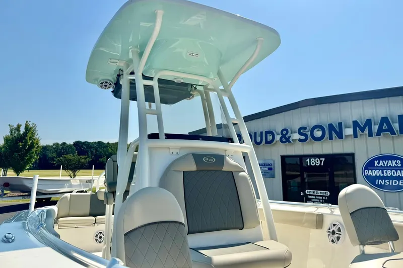 Slide: The Image of 2026 Key West 219 FS boat with T-top, displayed at a marine dealership. - 14