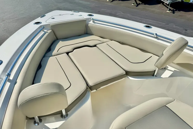 Slide: The Image of 2026 Key West 219 FS boat with beige cushioned seating in the bow area. - 17