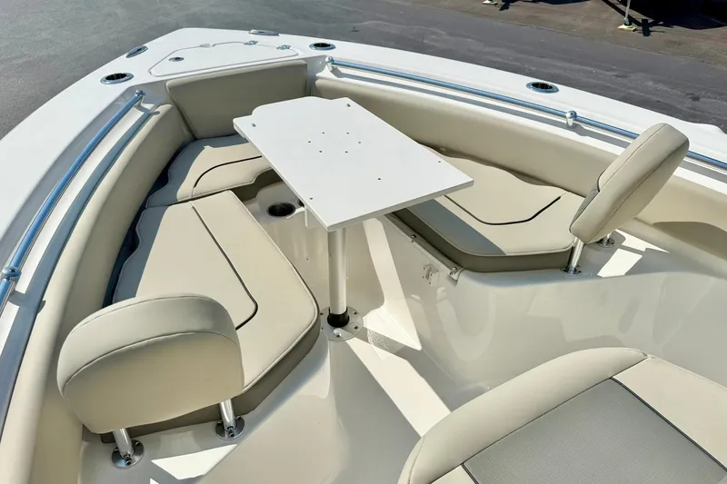 Slide: The Image of 2026 Key West 219 FS boat interior with beige seating and a central table. - 18