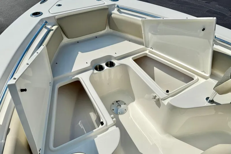 Slide: The Image of 2026 Key West 219 FS boat interior with open storage compartments and cup holders. - 21