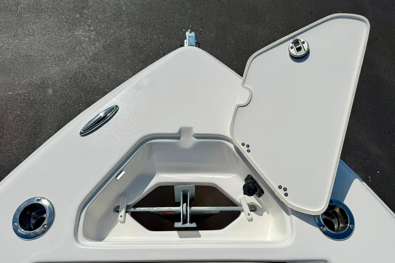 Slide: The Image of 2026 Key West 219 FS boat anchor compartment with open hatch, showcasing storage space. - 22