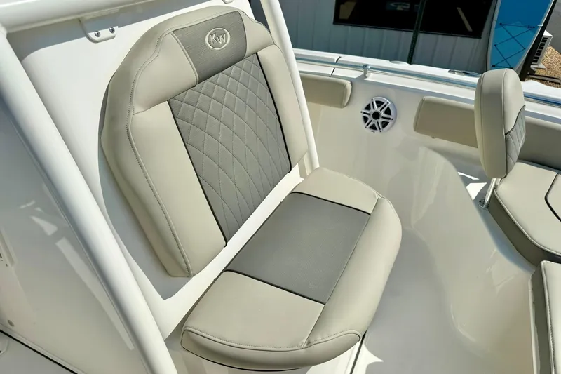 Slide: The Image of 2026 Key West 219 FS boat seat with beige and gray upholstery, featuring KW logo. - 24