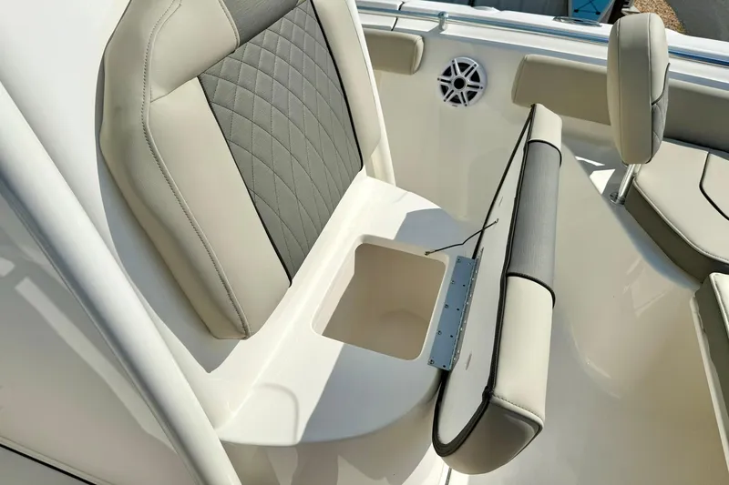 Slide: The Image of 2026 Key West 219 FS boat interior with cushioned seating and storage compartment. - 25