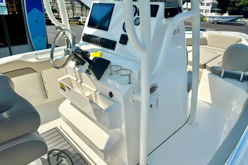 Slide: The Image of 2026 Key West 219 FS boat interior with steering console and seating area. - 27