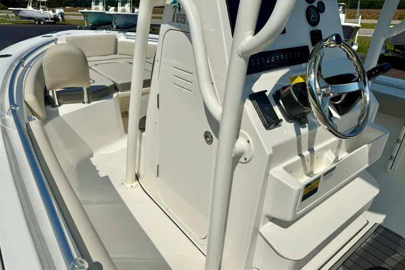 Slide: The Image of 2026 Key West 219 FS boat interior with steering console and seating area. - 29