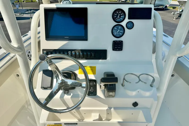 Slide: The Image of 2026 Key West 219 FS boat dashboard with steering wheel, gauges, and display screen. - 3