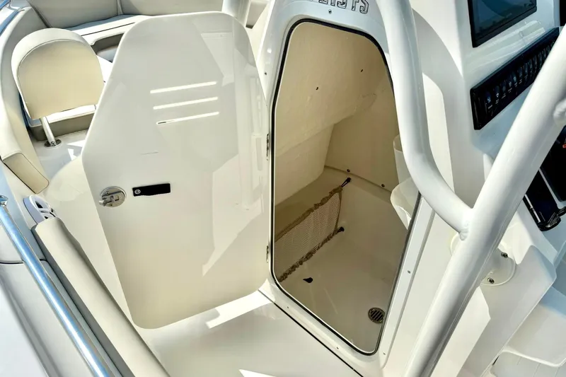 Slide: The Image of 2026 Key West 219 FS boat interior with open storage compartment and seating. - 30