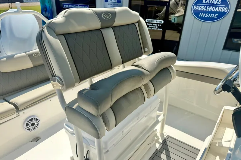 Slide: The Image of 2026 Key West 219 FS boat interior with cushioned seating and steering area. - 31