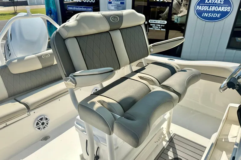 Slide: The Image of 2026 Key West 219 FS boat interior with cushioned seating and steering area. - 32