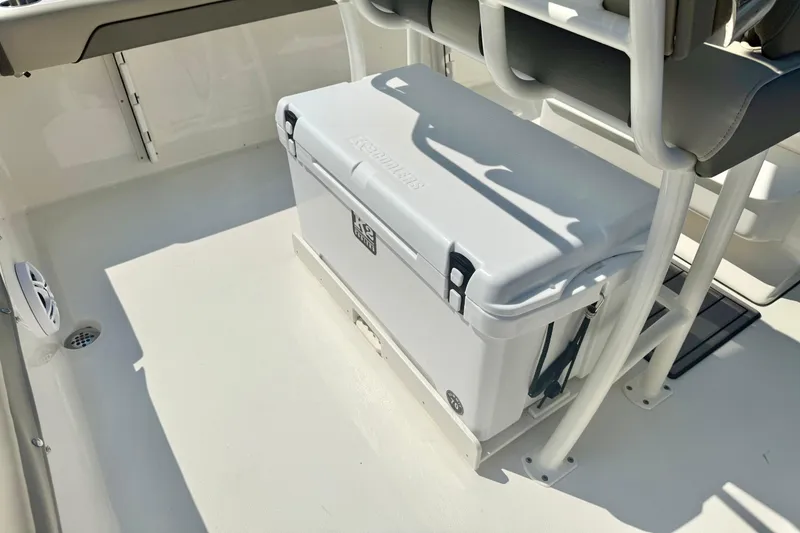 Slide: The Image of 2026 Key West 219 FS boat interior with cooler and seating arrangement. - 33