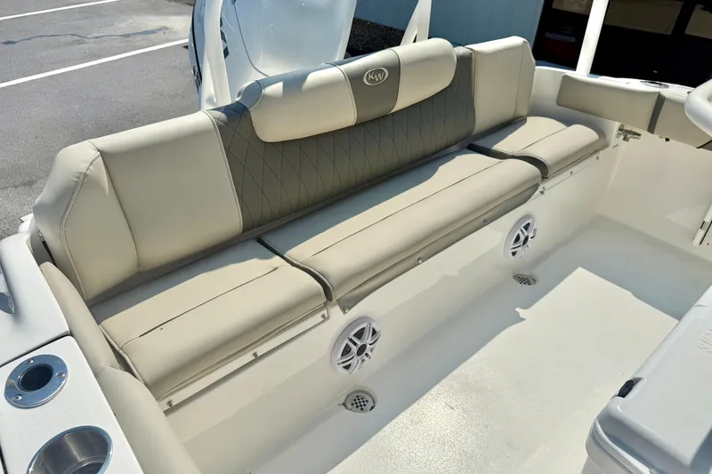 Slide: The Image of 2026 Key West 219 FS boat interior with beige seating and cup holders. - 36