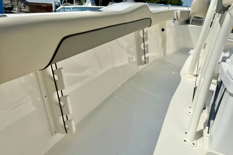 Slide: The Image of 2026 Key West 219 FS boat interior with rod holders and seating area. - 42