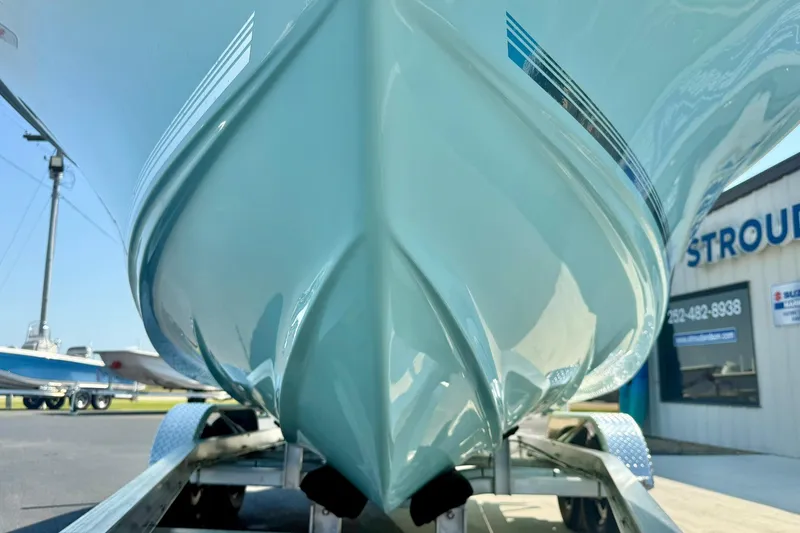 Slide: The Image of 2026 Key West 219 FS boat on trailer, close-up of hull design. - 9