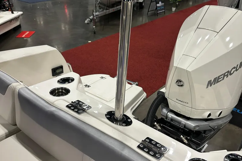 Slide: The Image of 2026 Sailfish 232 CC boat interior with Mercury engine, cup holders, and stainless steel pole. - 11