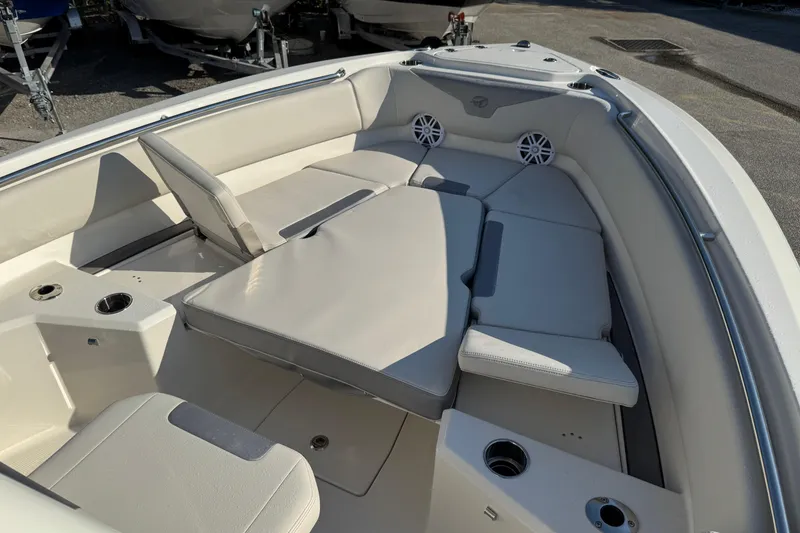 Slide: The Image of 2026 Sailfish 232 CC boat interior with cushioned seating and cup holders. - 14