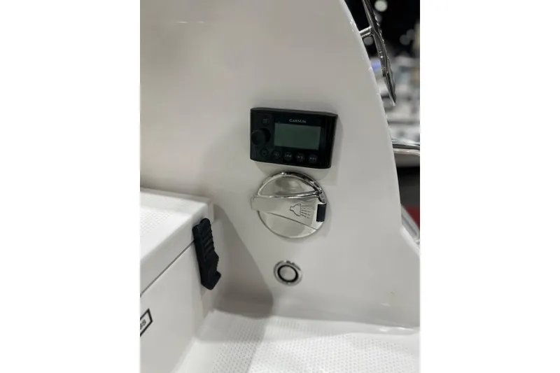 Slide: The Image of 2026 Sailfish 232 CC boat console with Garmin device and control panel. - 21