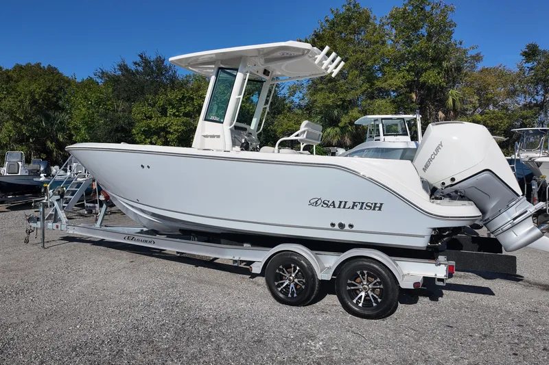 Slide: The Image of 2026 Sailfish 232 CC boat on trailer, parked outdoors, side view. - 3