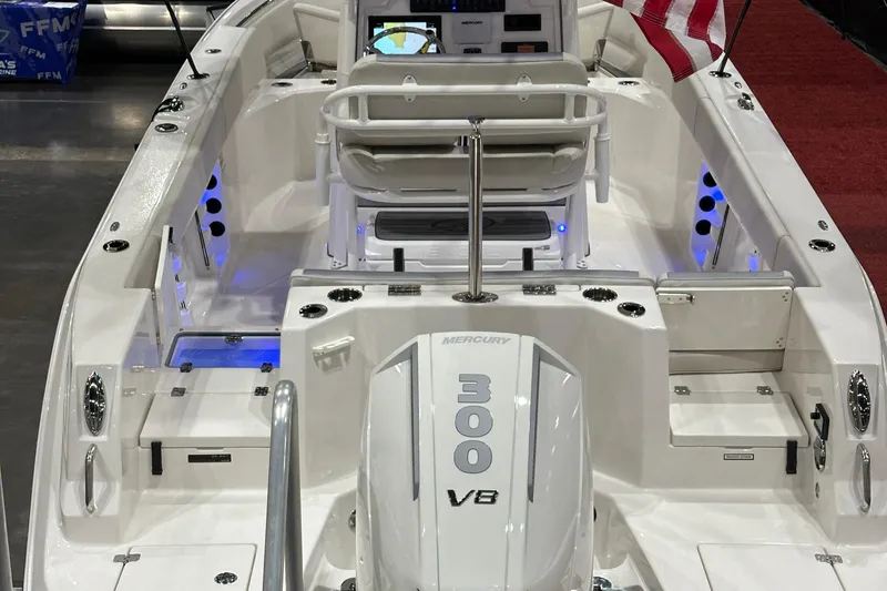 Slide: The Image of 2026 Sailfish 232 CC boat interior with Mercury 300 V8 engine, American flag displayed. - 7