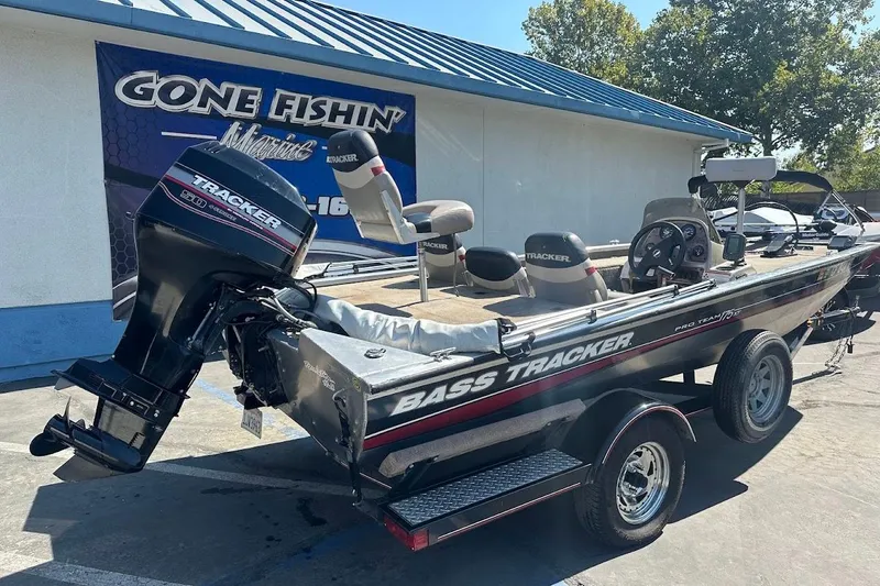 Slide: The Image of 2001 Bass Tracker Pro Team 175 boat parked at a dealership, featuring a Tracker outboard motor. - 10