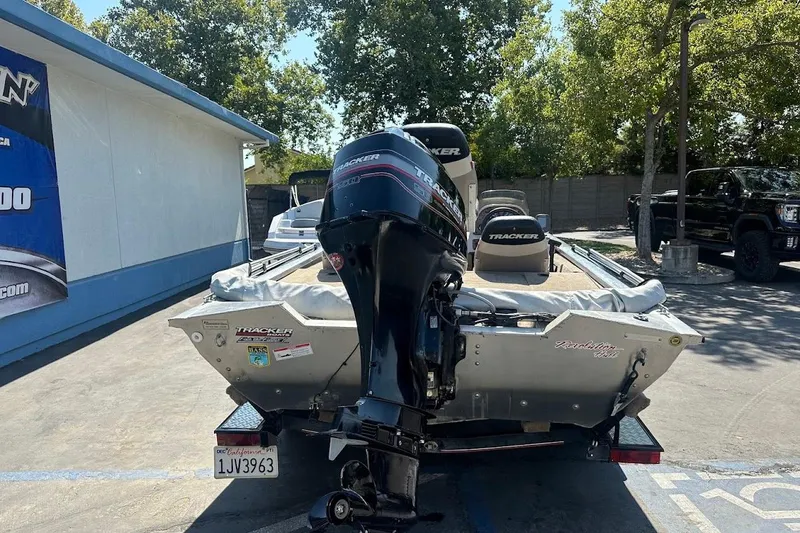 Slide: The Image of 2001 Bass Tracker Pro Team 175 boat with outboard motor in parking lot. - 11