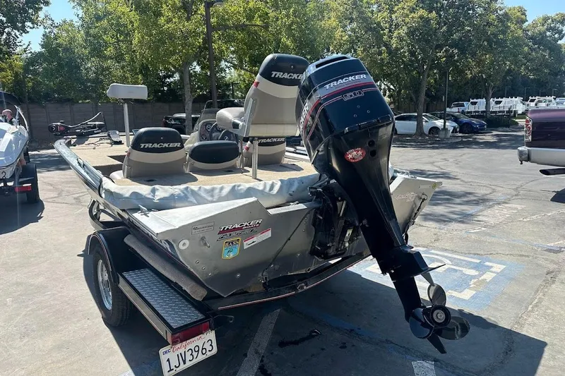 Slide: The Image of 2001 Bass Tracker Pro Team 175 boat with outboard motor in parking lot. - 12