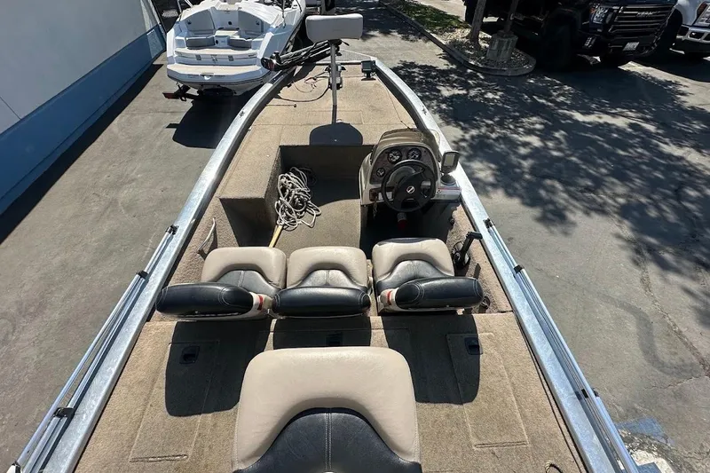 Slide: The Image of 2001 Bass Tracker Pro Team 175 boat interior with steering console and seating. - 13