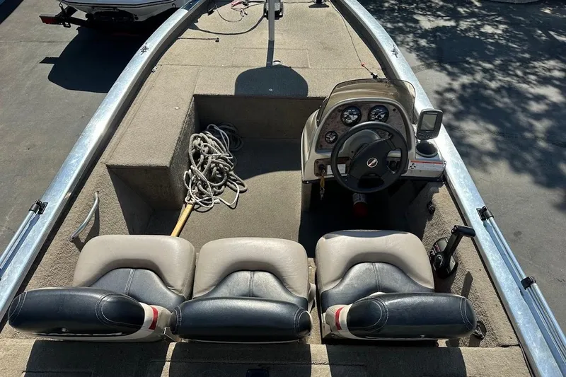 Slide: The Image of 2001 Bass Tracker Pro Team 175 boat interior with steering console and seating. - 14