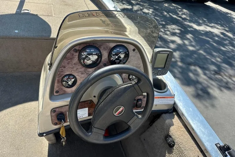 Slide: The Image of 2001 Bass Tracker Pro Team 175 dashboard with steering wheel and gauges. - 17