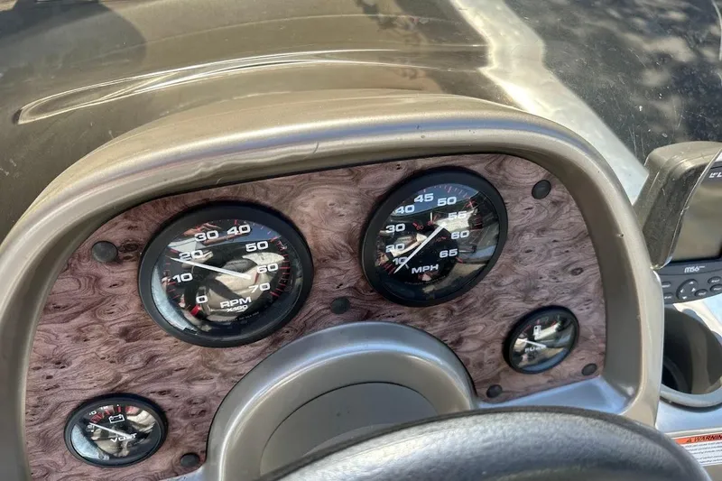 Slide: The Image of Dashboard of a 2001 Bass Tracker Pro Team 175 boat with speedometer and RPM gauges. - 19