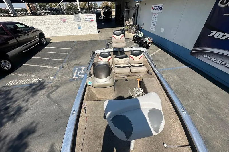 Slide: The Image of 2001 Bass Tracker Pro Team 175 boat in parking lot, featuring seating and equipment. - 25