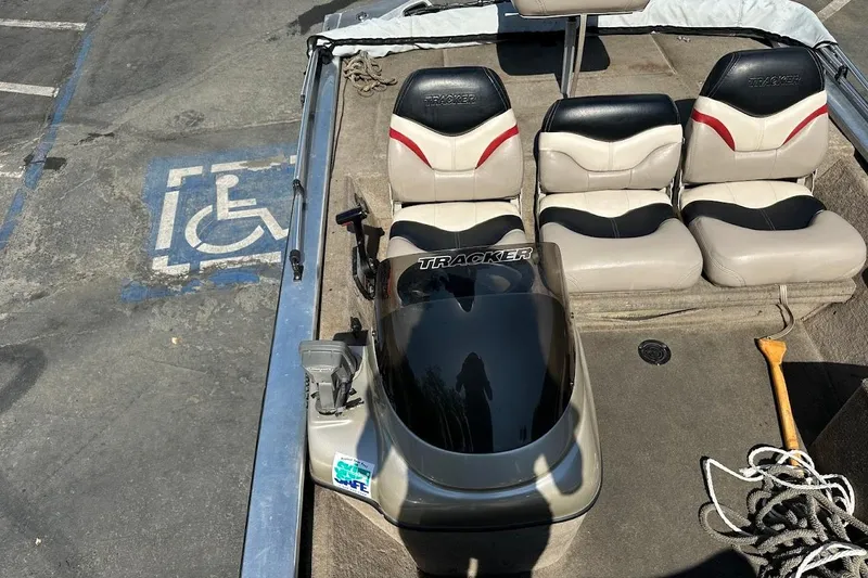 Slide: The Image of 2001 Bass Tracker Pro Team 175 boat interior with seating and steering console. - 26