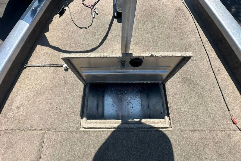 Slide: The Image of 2001 Bass Tracker Pro Team 175 boat interior with open storage compartment. - 27