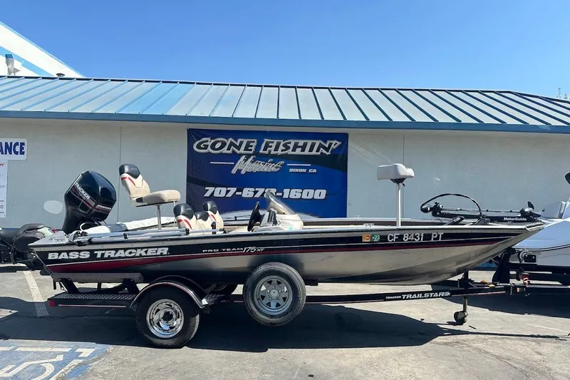 Slide: The Image of 2001 Bass Tracker Pro Team 175 boat on trailer outside marine shop. - 3