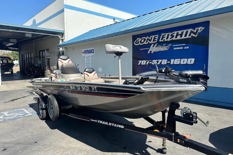 Slide: The Image of 2001 Bass Tracker Pro Team 175 boat on trailer outside marine shop. - 4