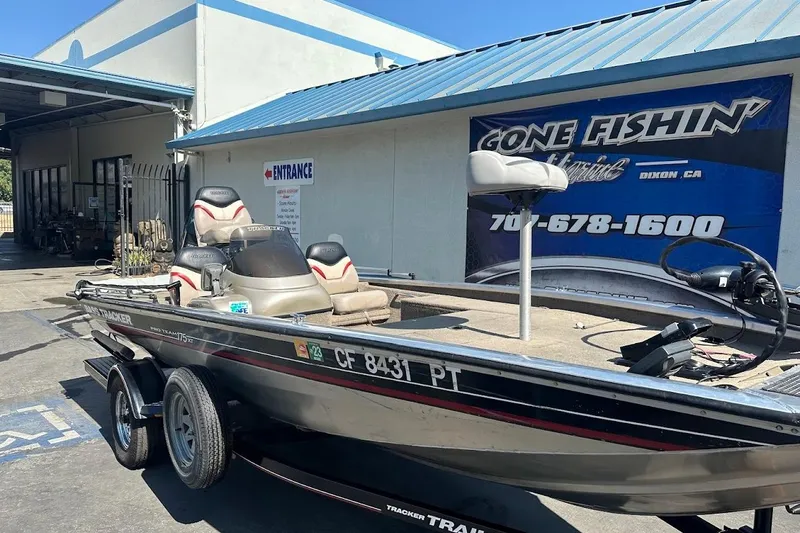 Slide: The Image of 2001 Bass Tracker Pro Team 175 boat parked outside a fishing store. - 8