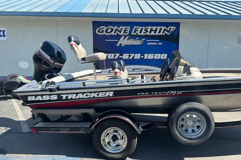 Slide: The Image of 2001 Bass Tracker Pro Team 175 boat on trailer, parked outside a marine store. - 9