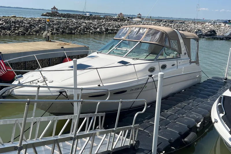 Slide: The Image of 2001 Sea Ray 290 Sundancer docked at marina with scenic waterfront view. - 3