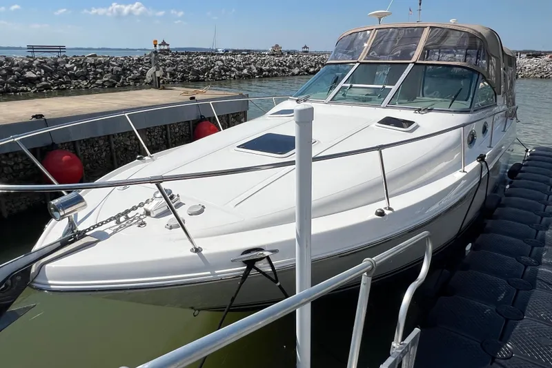 Slide: The Image of 2001 Sea Ray 290 Sundancer docked at marina, clear sky, calm water. - 4