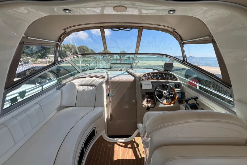 Slide: The Image of Interior of 2001 Sea Ray 290 Sundancer boat with steering wheel and seating. - 9