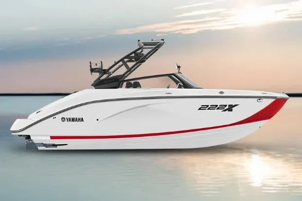 The Image of 2026 Yamaha Boats 222XD, sleek white design, red accent, on calm water at sunset. - 0