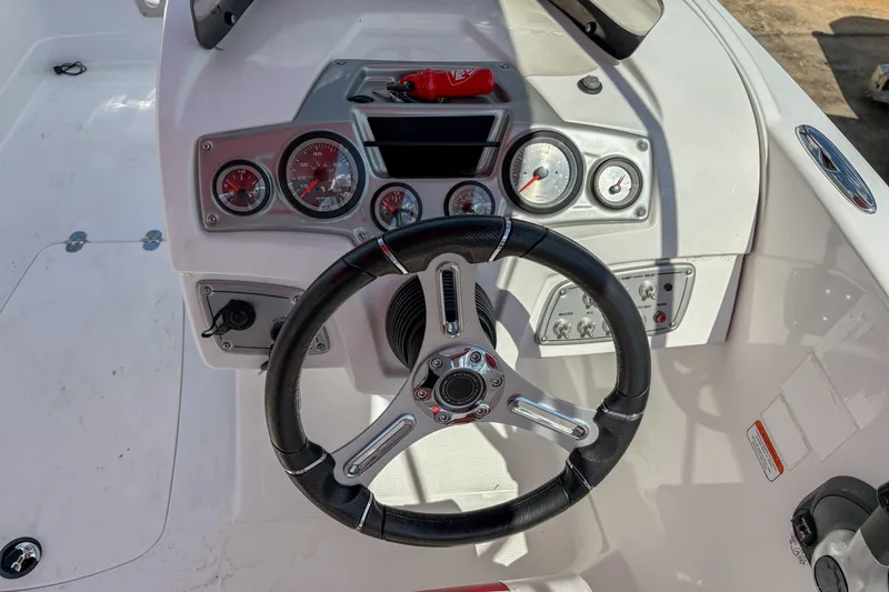 Slide: The Image of Steering console of a 2019 Tahoe 2150 boat with gauges and controls. - 10