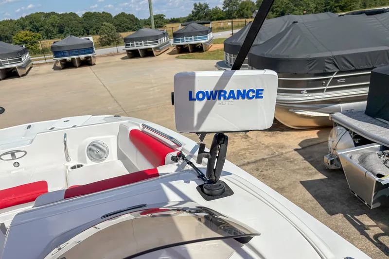 Slide: The Image of 2019 Tahoe 2150 boat with Lowrance Elite system, red seating, and covered pontoons in background. - 11