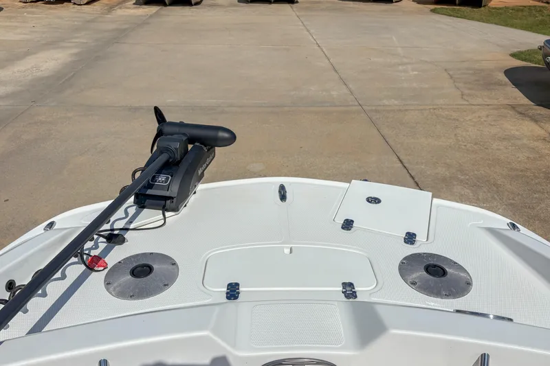 Slide: The Image of 2019 Tahoe 2150 boat with trolling motor on deck, parked on concrete surface. - 14