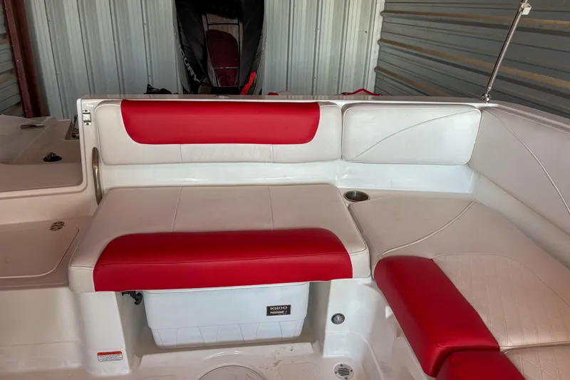 Slide: The Image of 2019 Tahoe 2150 boat interior with red and white seating in storage. - 18