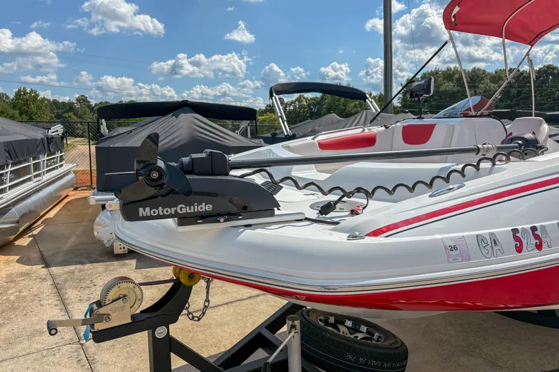 Slide: The Image of 2019 Tahoe 2150 boat with MotorGuide trolling motor on trailer, under a sunny sky. - 5