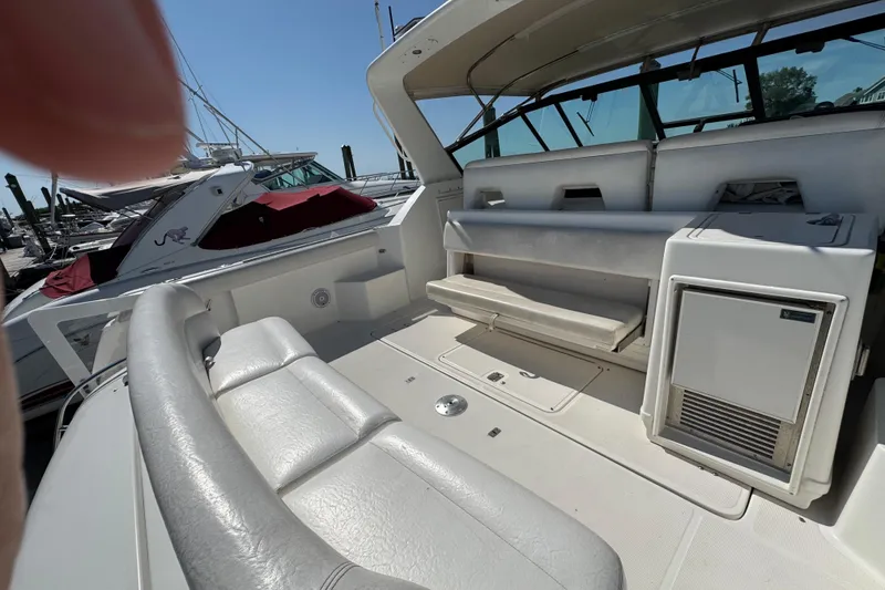 Slide: The Image of 2000 Tiara Yachts 3500 Express boat interior with seating and storage. - 12