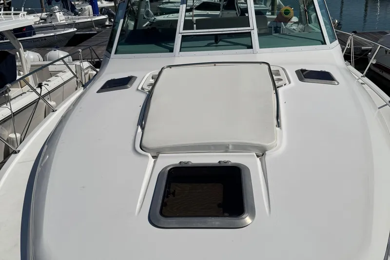 Slide: The Image of 2000 Tiara Yachts 3500 Express boat deck with open hatch, docked at marina. - 16